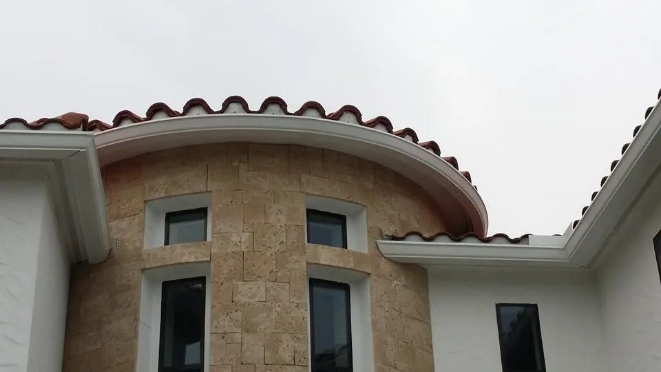 Curved white gutter round stone turret clay tile roof, Sanford